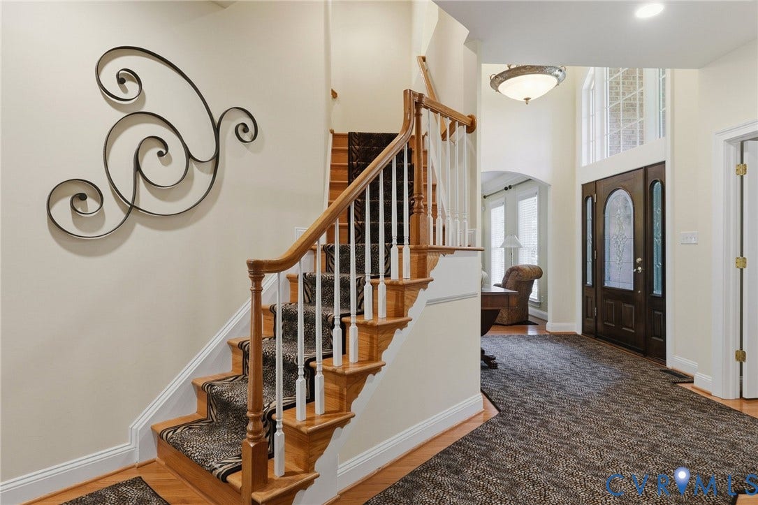 3012 Hedgeway Place, Tarrington, Midlothian, VA 23113 Two-story foyer featuring a wood staircase with white balusters, transom windows, a dark wood-finish entry door with decorative glass, and a semi-flush mount ceiling fixture