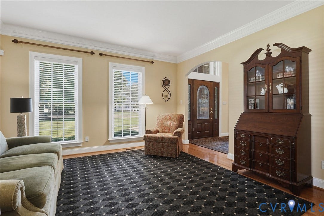 3012 Hedgeway Place, Tarrington, Midlothian, VA 23113 Arched entry with a wood door, wood-finish flooring, two large windows, and crown molding