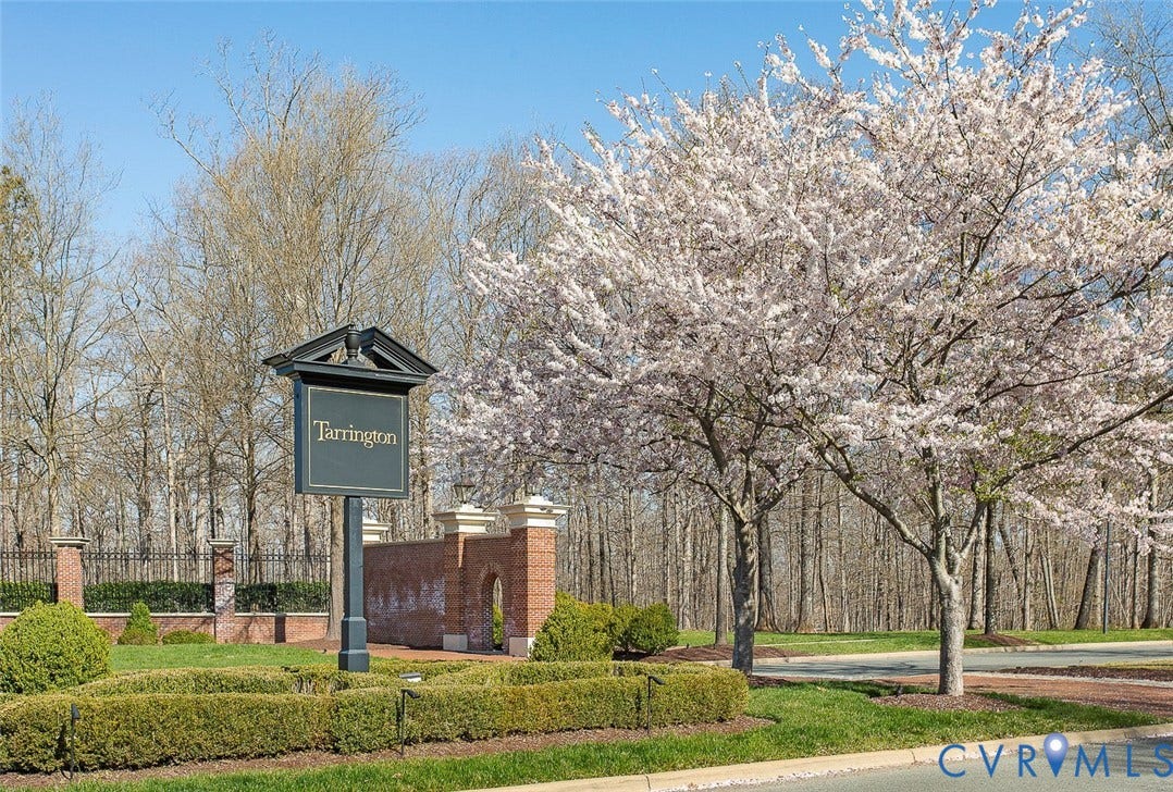 3012 Hedgeway Place, Tarrington, Midlothian, VA 23113 Tarrington community signage with brick and wrought iron fencing, manicured shrubbery, and mature flowering trees