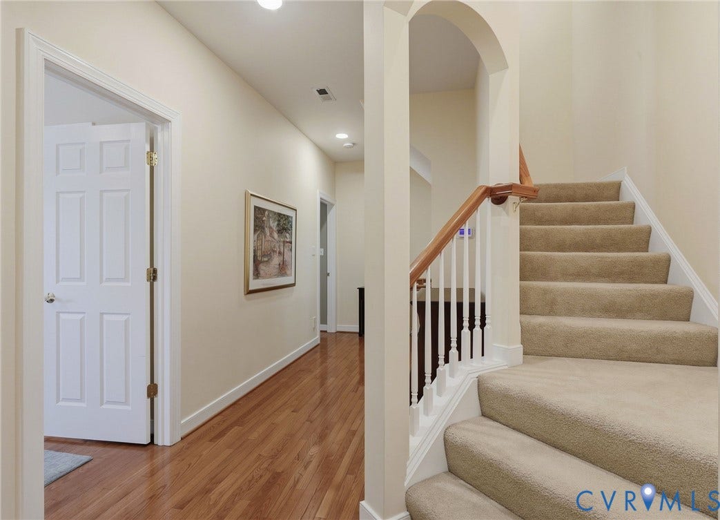 3012 Hedgeway Place, Tarrington, Midlothian, VA 23113 Hallway featuring wood-finish flooring, recessed lighting, and a staircase with carpeted treads, white balusters, and a wood handrail