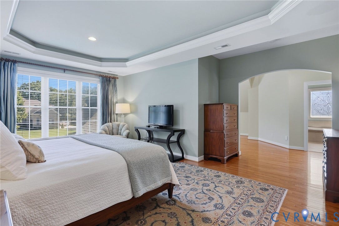 3012 Hedgeway Place, Tarrington, Midlothian, VA 23113 Tray ceiling with recessed lighting, large window with ample natural light, wood-finish flooring, and arched doorway