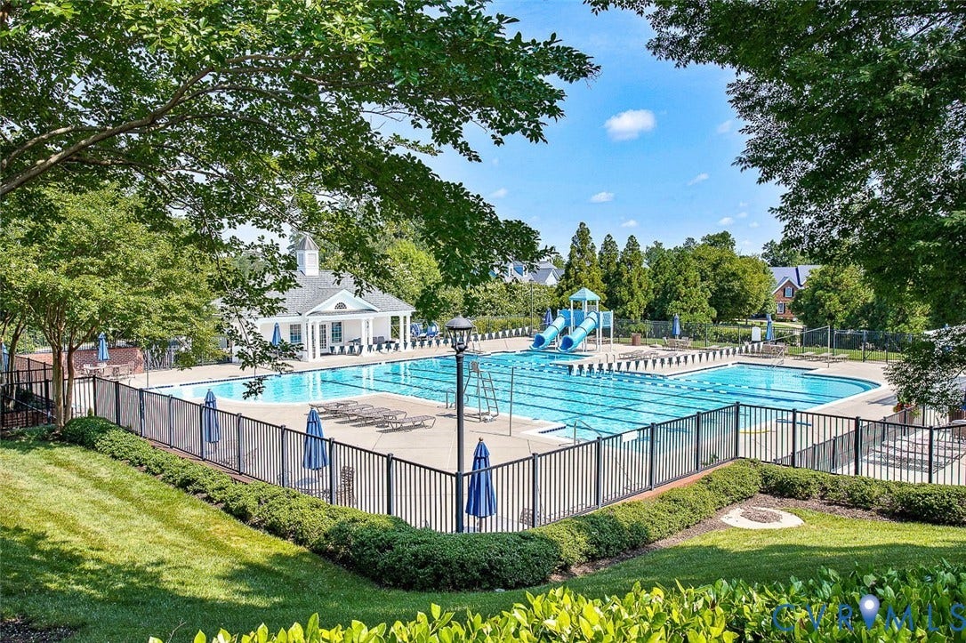 3012 Hedgeway Place, Tarrington, Midlothian, VA 23113 Expansive community pool with multiple swimming lanes, two water slides, a dedicated wading area, and a clubhouse
