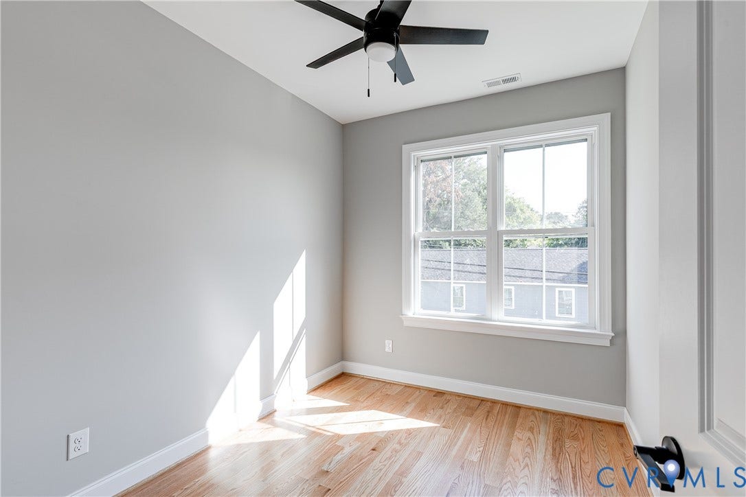 Hardwood flooring, painted walls, white trim, and a ceiling fan