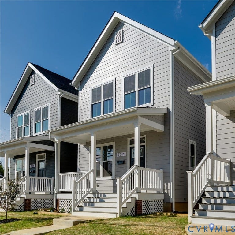Gray siding exterior with white trim, a covered porch, white porch railings, and traditional steps