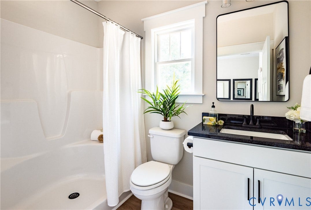 1343 Stokes Station Road, Goochland, VA 23063 White vanity with black countertop, rectangular undermount sink, and black faucet