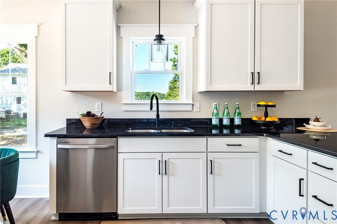 1343 Stokes Station Road, Goochland, VA 23063 White shaker-style cabinetry with black hardware, dark countertops, stainless steel dishwasher, and a black gooseneck faucet