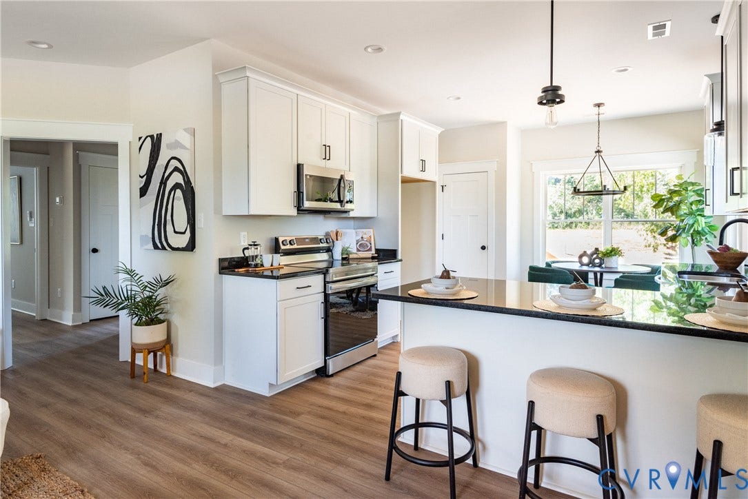 1343 Stokes Station Road, Goochland, VA 23063 Kitchen featuring white cabinetry, black stone countertops, stainless steel appliances, and pendant lighting