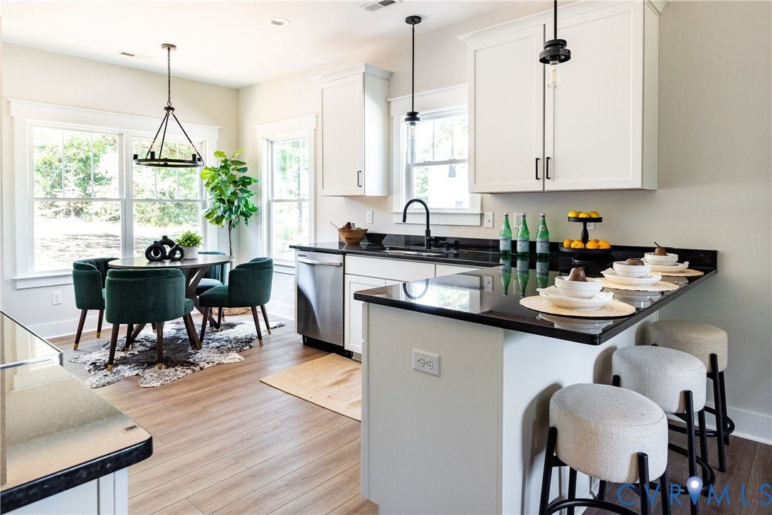 1343 Stokes Station Road, Goochland, VA 23063 white cabinetry with black hardware, black countertops, stainless steel dishwasher, and a black gooseneck faucet