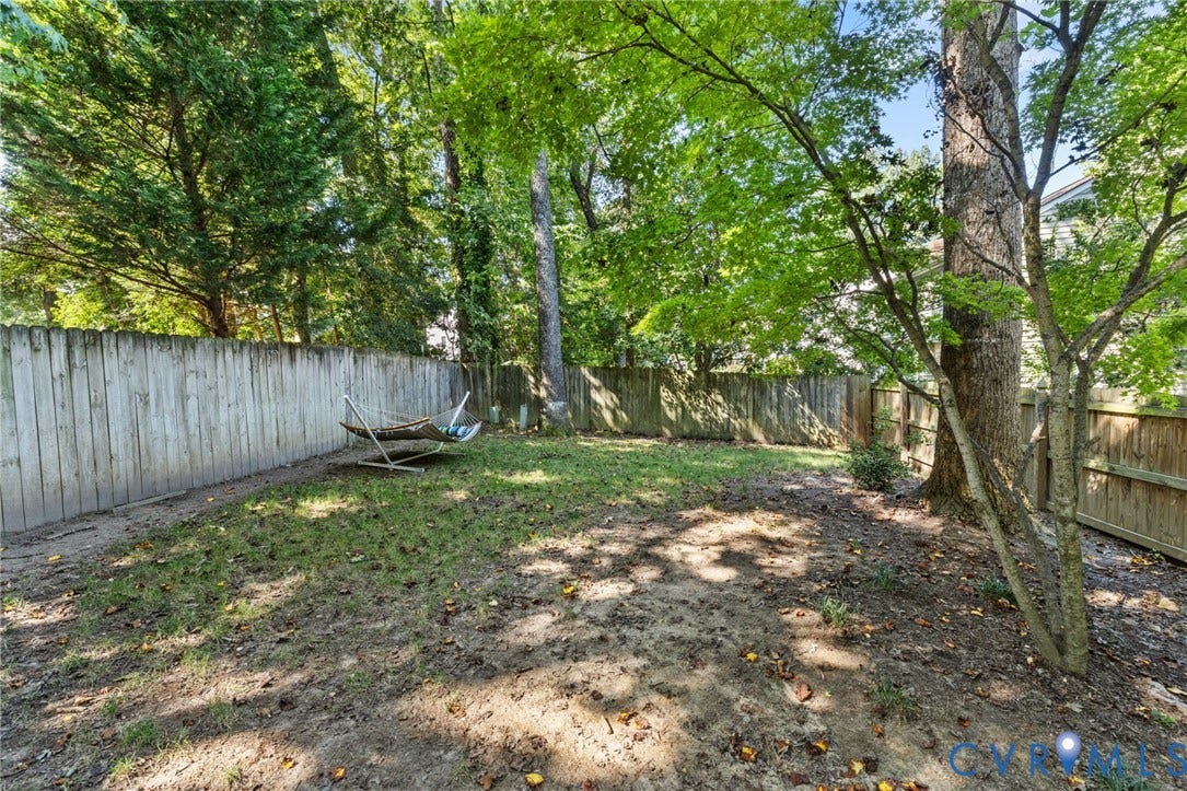 10407 Silverbrook Drive, Henrico, VA 23233 Expansive backyard featuring mature trees and a wood fence perimeter
