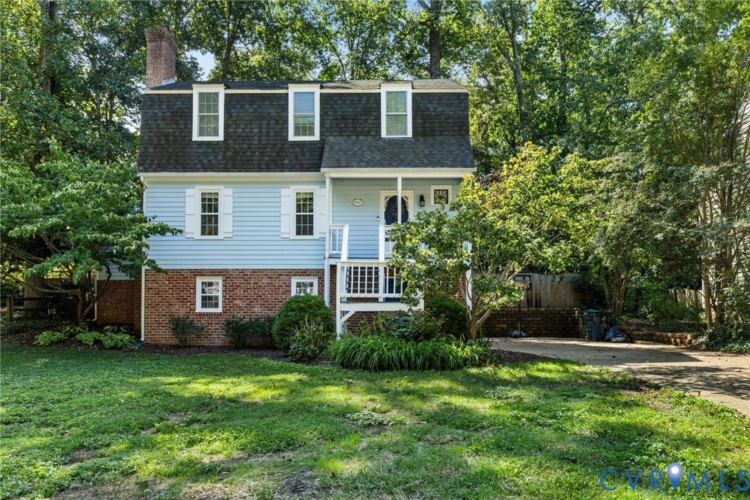 10407 Silverbrook Drive, Henrico, VA 23233 Dormer windows, light blue siding, brick foundation, front porch, and mature trees