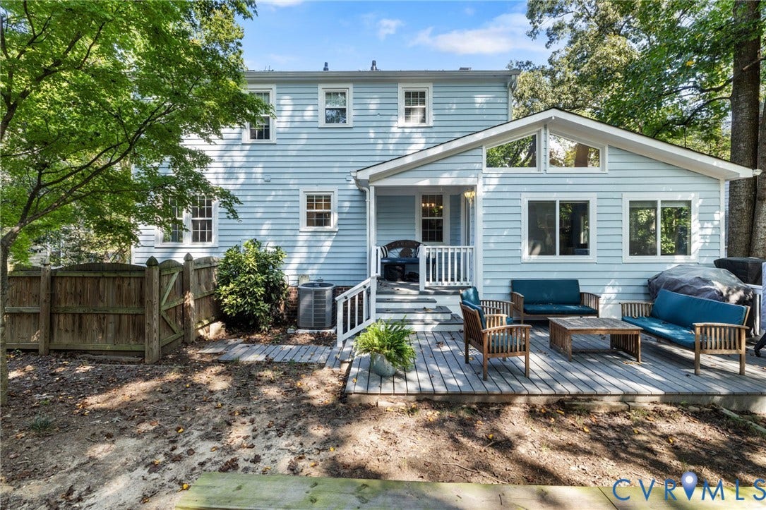 10407 Silverbrook Drive, Henrico, VA 23233 Expansive rear deck, light blue siding, white window trim, multiple large windows, and a raised covered porch