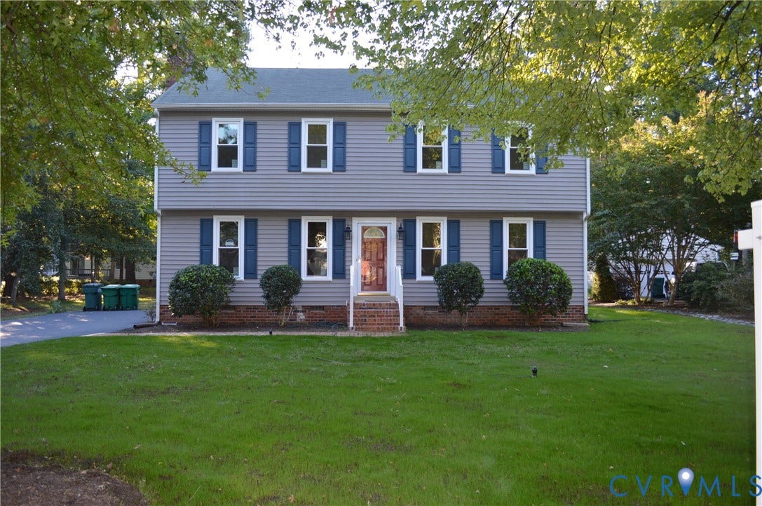 10227 Acworth Drive, Glen Allen, VA 23060 Two-story residence featuring light gray siding with white window trim and blue shutters