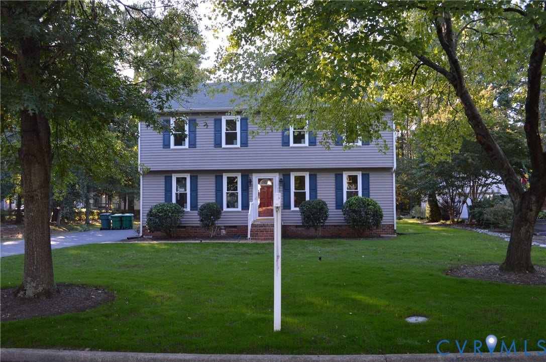 10227 Acworth Drive, Glen Allen, VA 23060 Two-story residence featuring siding exterior, blue decorative window shutters, and a front entry with a red door