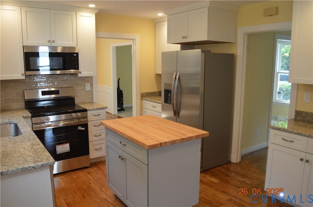 10227 Acworth Drive, Glen Allen, VA 23060 Kitchen featuring wood-finish flooring, white cabinetry, a central island with a butcher block countertop, stainless steel appliances, and granite countertops