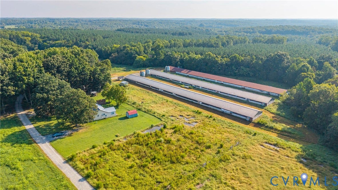 78 Bowling Lane, Cumberland, VA 23040 Extensive land with multiple agricultural structures, a residential building, and a gravel driveway