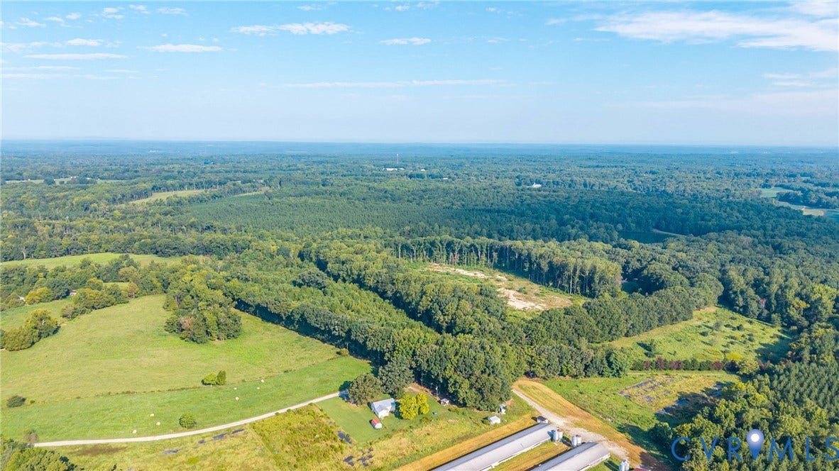 78 Bowling Lane, Cumberland, VA 23040 Expansive rural property featuring multiple cleared fields, extensive wooded areas, and agricultural structures
