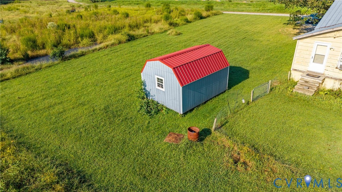 78 Bowling Lane, Cumberland, VA 23040 Expansive lawn with a detached storage shed featuring a red metal roof and a single window
