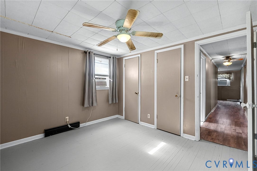 78 Bowling Lane, Cumberland, VA 23040 Window-mounted air conditioning unit, ceiling fan with light fixture, two interior doors, and paneling on walls