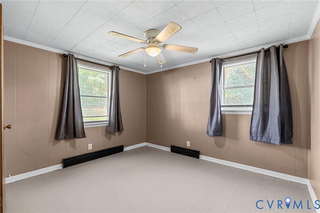 78 Bowling Lane, Cumberland, VA 23040 Neutral wall paneling, two windows, ceiling fan with integrated lighting, and light-toned flooring