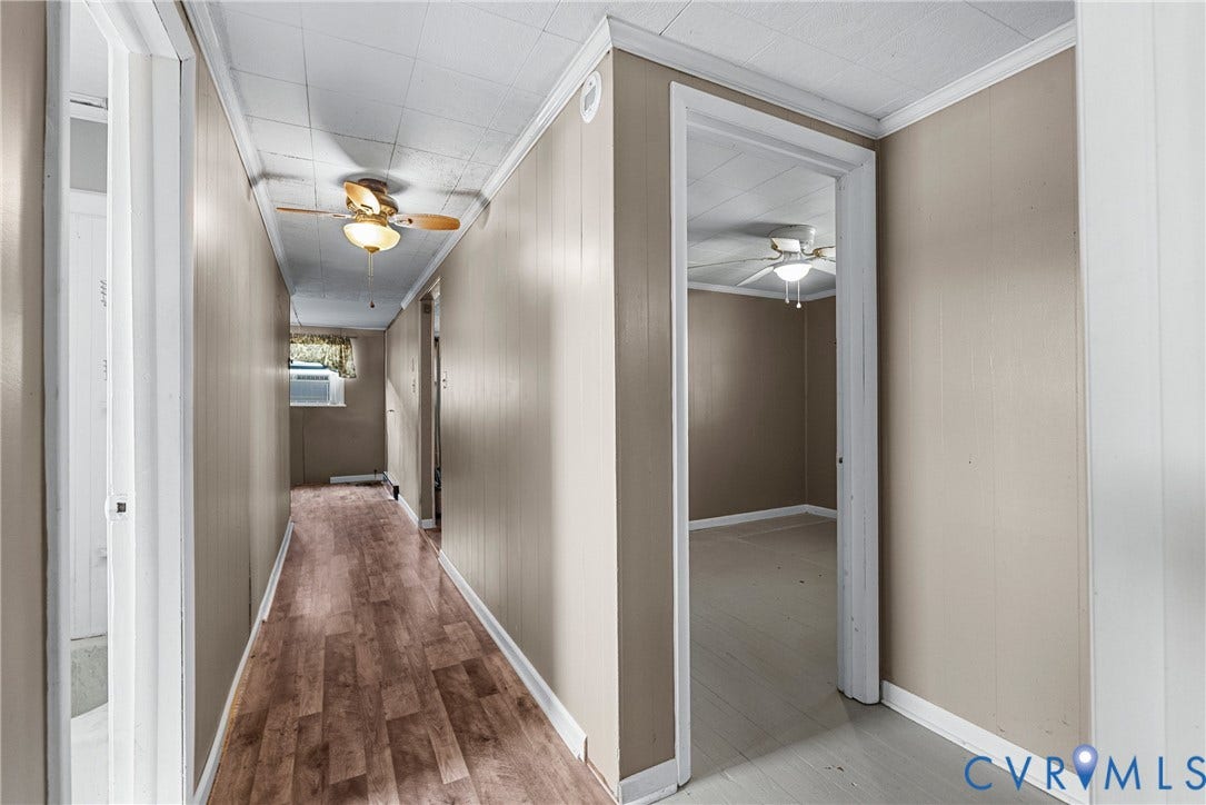 78 Bowling Lane, Cumberland, VA 23040 Hallway featuring wood-finish flooring, light-toned wall paneling, and ceiling fan with integrated lighting