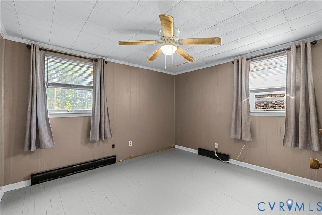 78 Bowling Lane, Cumberland, VA 23040 Wood-finish flooring, paneled wall finish, ceiling fan with integrated lighting, window-mounted air conditioning unit, and baseboard heating