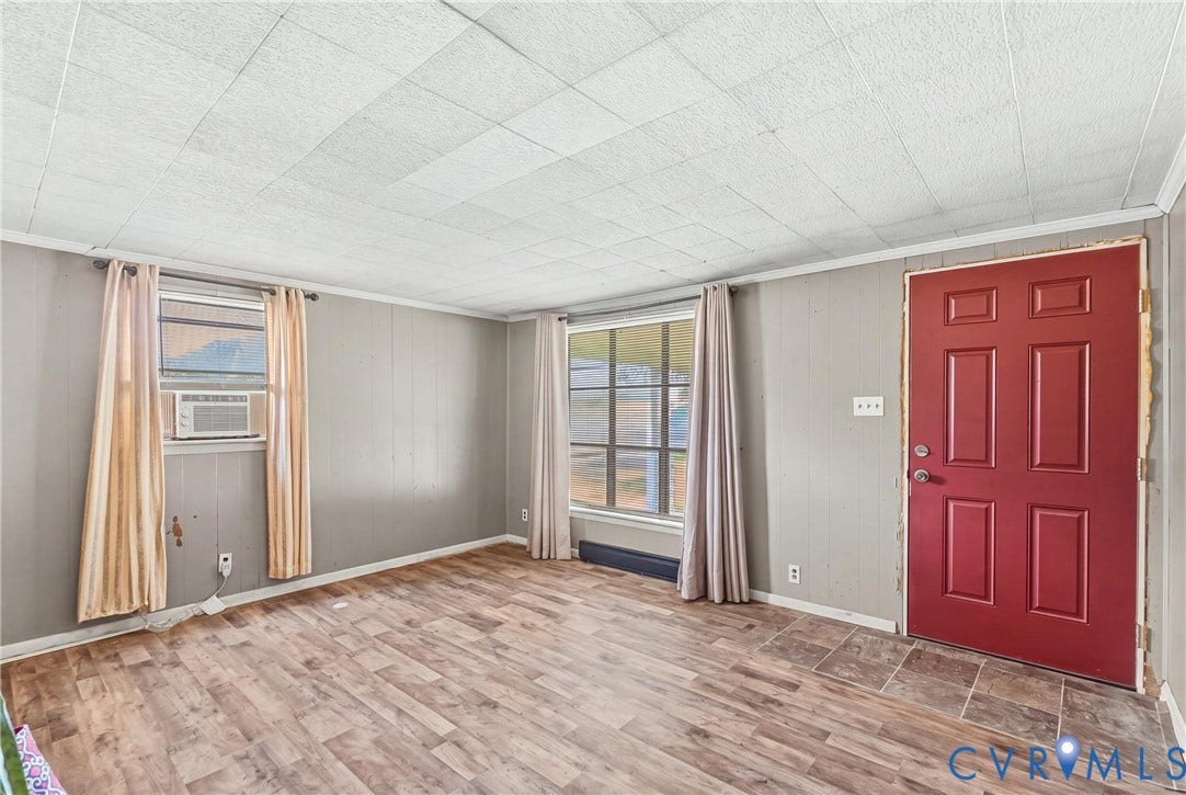 78 Bowling Lane, Cumberland, VA 23040 Wood-finish flooring, paneled walls, white ceiling tiles, and a red panel door