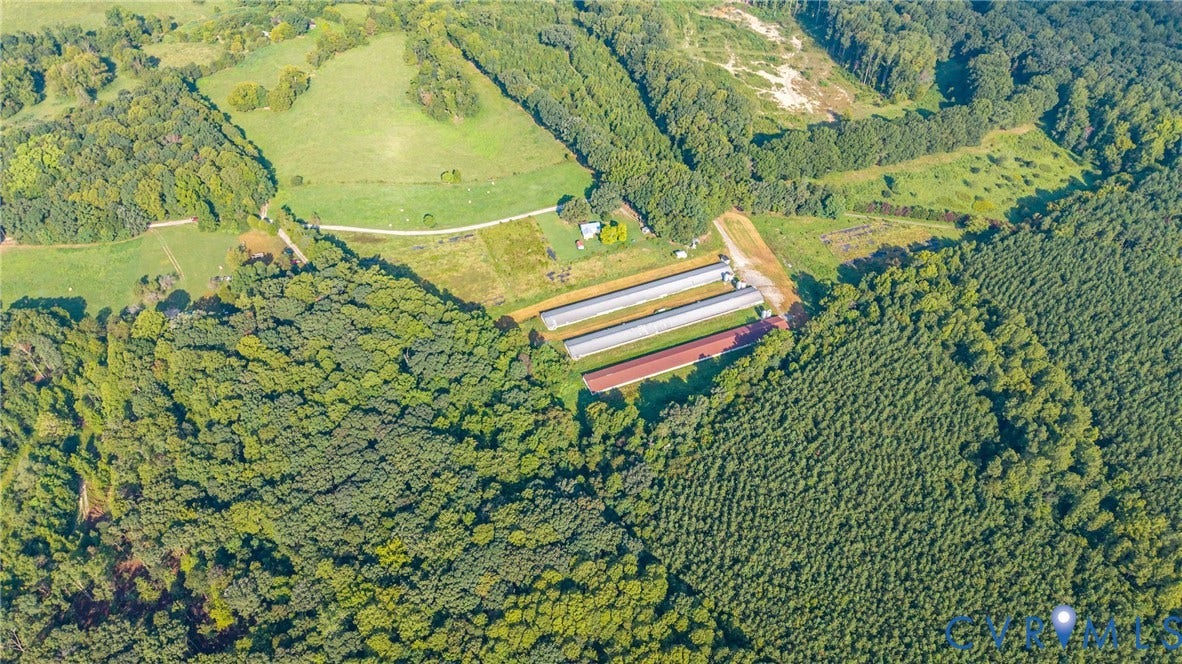 78 Bowling Lane, Cumberland, VA 23040 Expansive acreage featuring established pastures, dense tree lines, and multiple agricultural structures