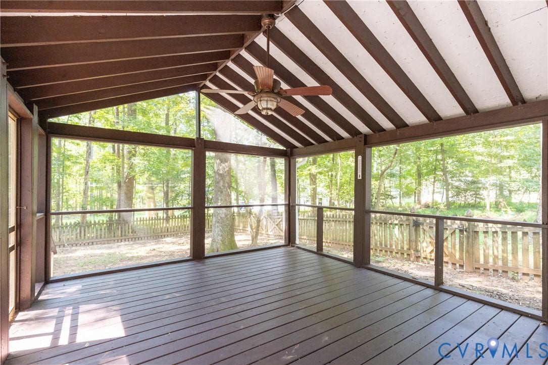 2765 Briarpatch Lane, Powhatan, VA 23139 Spacious screened porch featuring a vaulted ceiling with exposed beams, wood-finish flooring, and an integrated ceiling fan, overlooking a fenced yard