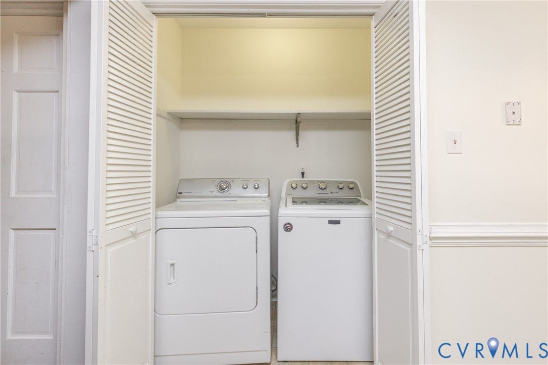 2765 Briarpatch Lane, Powhatan, VA 23139 Laundry area with louvered bi-fold doors, upper shelving, and white walls