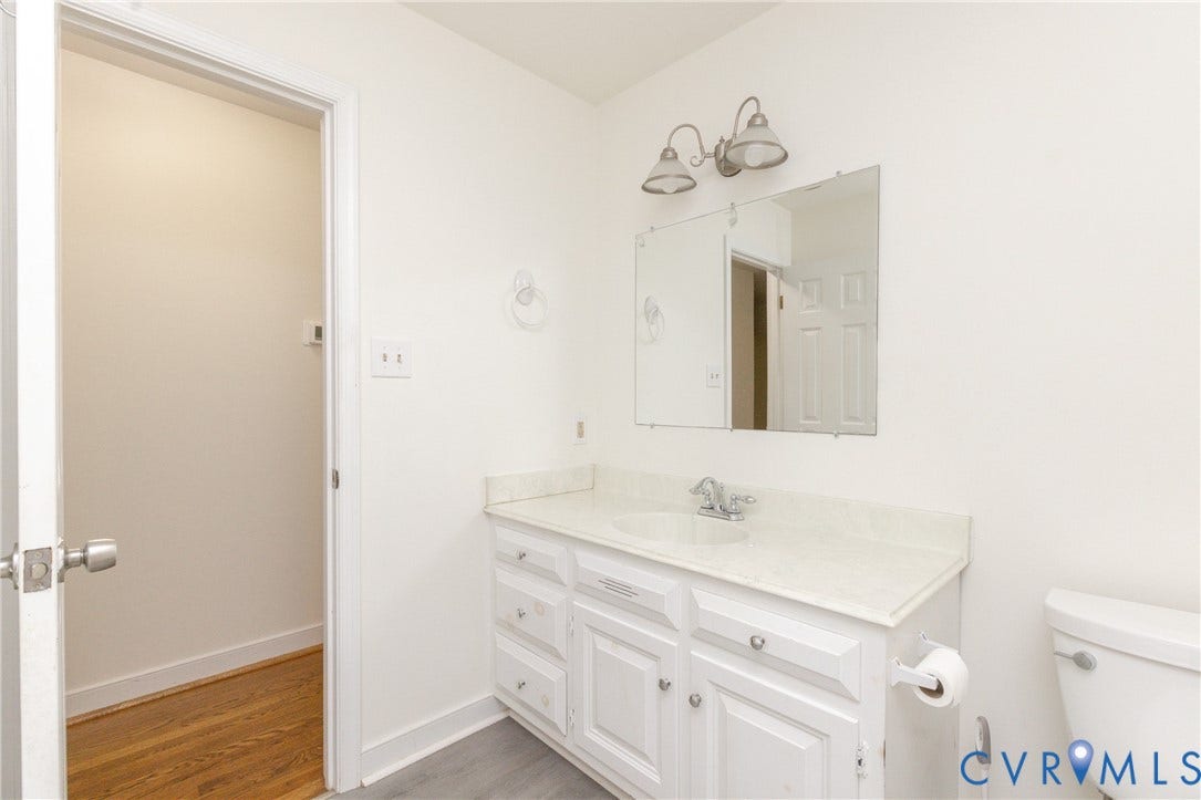 2765 Briarpatch Lane, Powhatan, VA 23139 White vanity with a single basin sink, light-colored countertop, and framed mirror