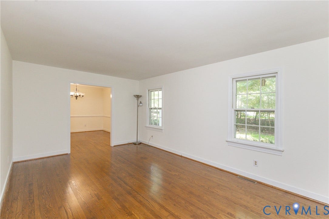 2765 Briarpatch Lane, Powhatan, VA 23139 Hardwood flooring, white walls, and a cased opening to a dining area with chair rail molding