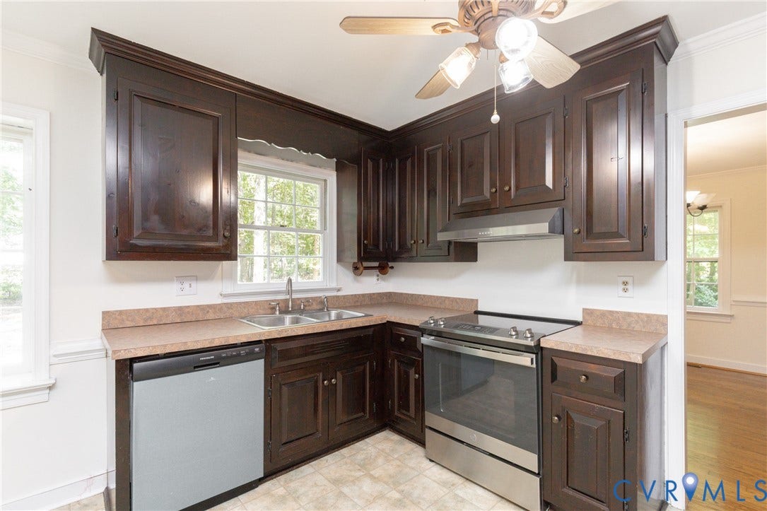 2765 Briarpatch Lane, Powhatan, VA 23139 Kitchen featuring dark wood cabinetry, stainless steel appliances, a double basin sink, and a ceiling fan with integrated lighting