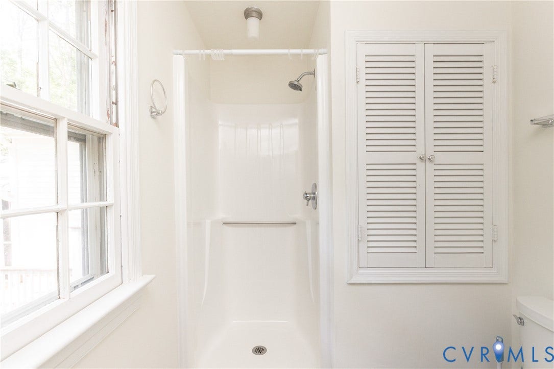 2765 Briarpatch Lane, Powhatan, VA 23139 Shower stall with white surround, chrome fixtures, and a window with white trim