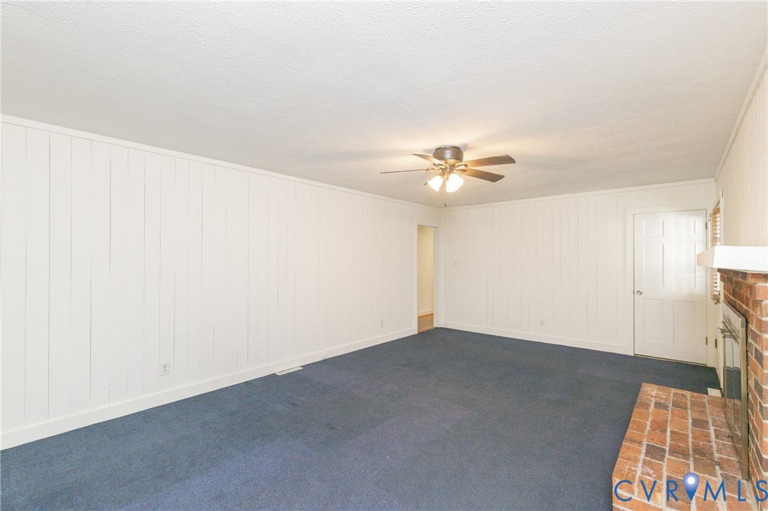 2765 Briarpatch Lane, Powhatan, VA 23139 White paneled walls, ceiling fan with integrated lighting, brick-finish fireplace, and blue carpeting
