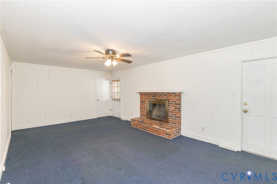 2765 Briarpatch Lane, Powhatan, VA 23139 Brick fireplace with brass insert, paneled walls, ceiling fan with integrated lighting, and carpeted flooring