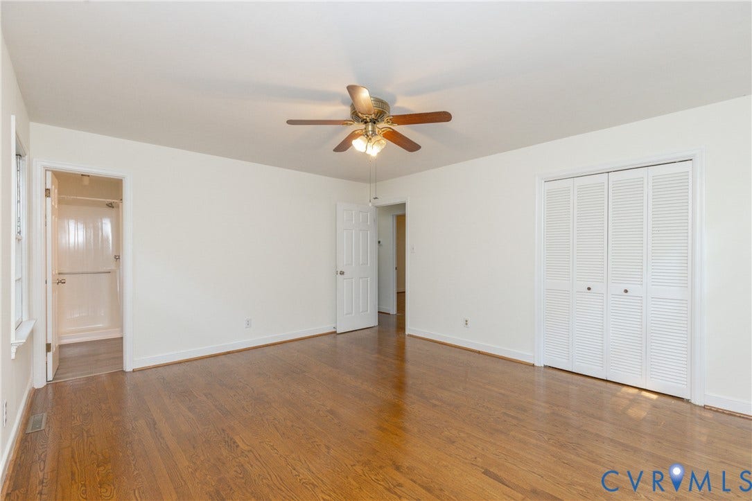 2765 Briarpatch Lane, Powhatan, VA 23139 Hardwood flooring, ceiling fan with integrated lighting, white louvered closet doors, white paneled interior doors, and a white shower stall
