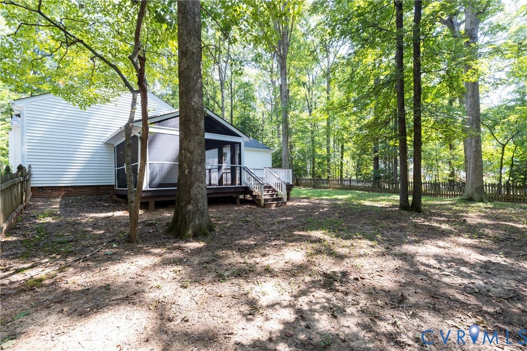 2765 Briarpatch Lane, Powhatan, VA 23139 Rear exterior with white siding, screened porch with wood decking, and a raised exterior deck with white railings