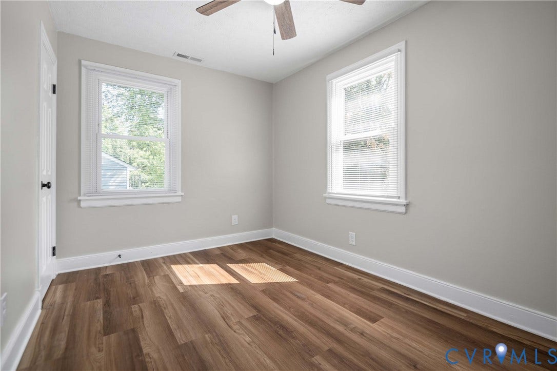 5429 Parker Street, Fulton Hill, Richmond, VA 23231 Wood-finish flooring, two windows with blinds, ceiling fan, and light gray wall finish