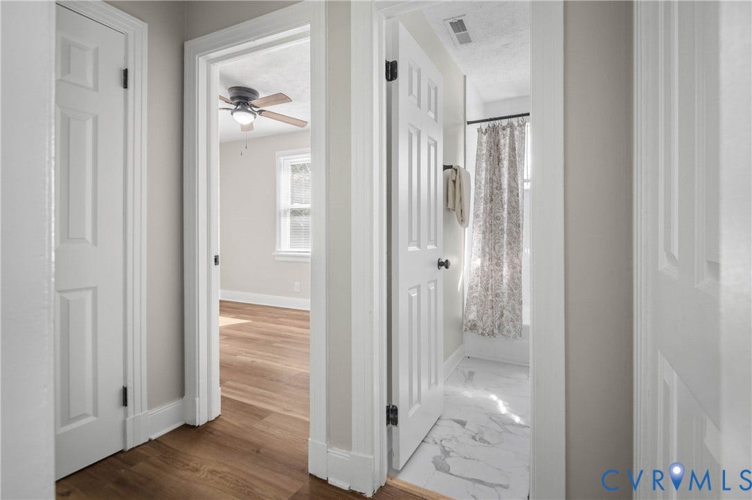 5429 Parker Street, Fulton Hill, Richmond, VA 23231 Wood-finish flooring, white paneled doors, ceiling fan with integrated lighting, white trim, and white walls