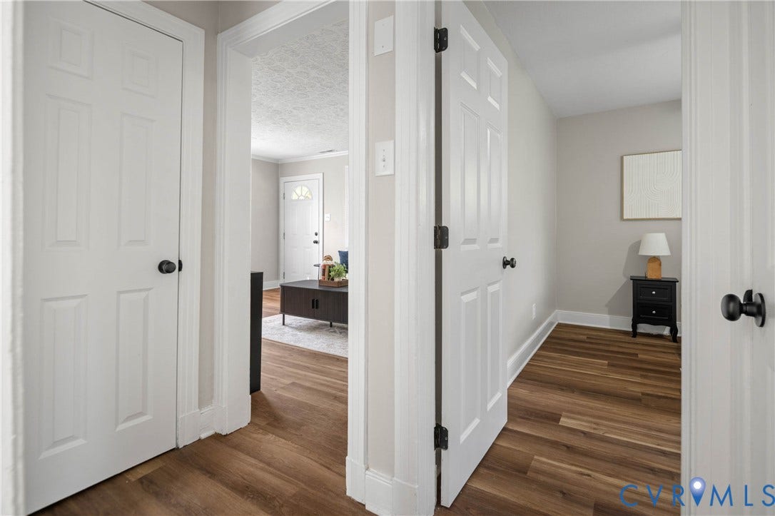 5429 Parker Street, Fulton Hill, Richmond, VA 23231 Wood-finish flooring throughout, white paneled doors with matte black hardware, and light neutral wall colors
