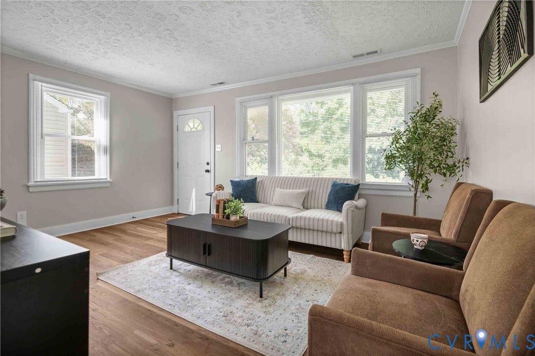 5429 Parker Street, Fulton Hill, Richmond, VA 23231 Wood-finish flooring, white trim, and a white front door with a half-moon window