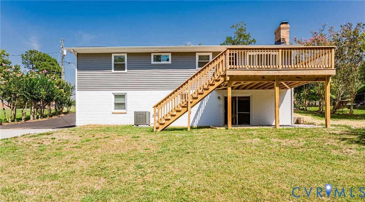 2702 Manchester Drive, New Birchett Estates, Prince George, VA 23875 Wood deck with a built-in staircase, gray siding, and a white foundation