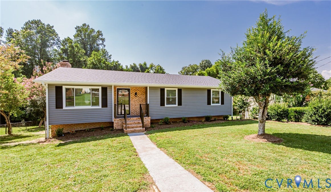 2702 Manchester Drive, New Birchett Estates, Prince George, VA 23875 Single-story residence featuring light blue siding, black shutters, and an inviting front porch with brick stairs