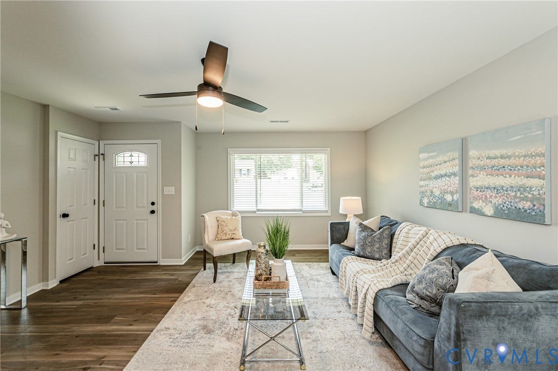 2702 Manchester Drive, New Birchett Estates, Prince George, VA 23875 Wood-finish flooring with a light-toned area rug, neutral wall tones, and a ceiling fan with integrated lighting