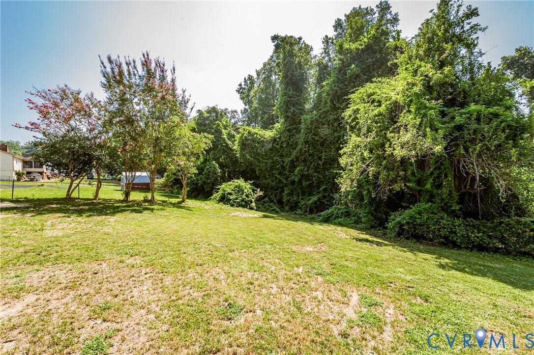 2702 Manchester Drive, New Birchett Estates, Prince George, VA 23875 Expansive grassy area with mature trees and dense foliage