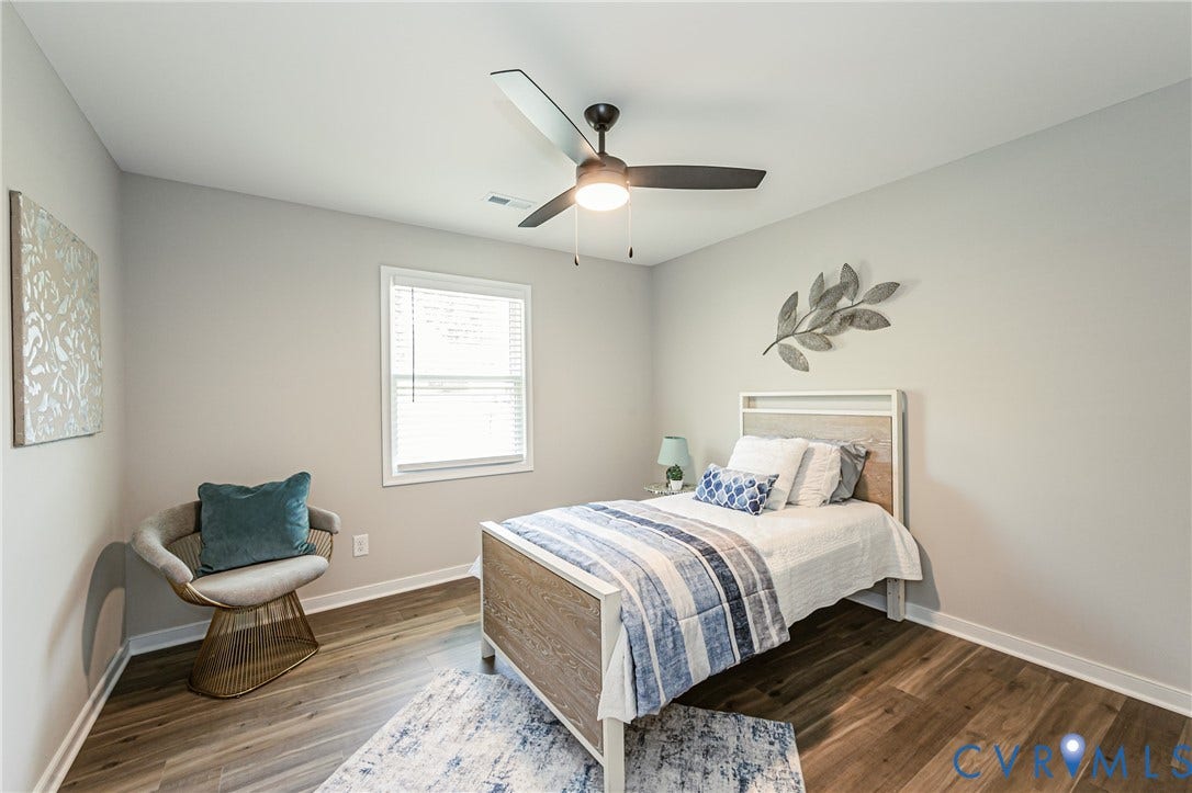 2702 Manchester Drive, New Birchett Estates, Prince George, VA 23875 Neutral paint, wood-finish flooring, white window trim, and a ceiling fan with integrated lighting