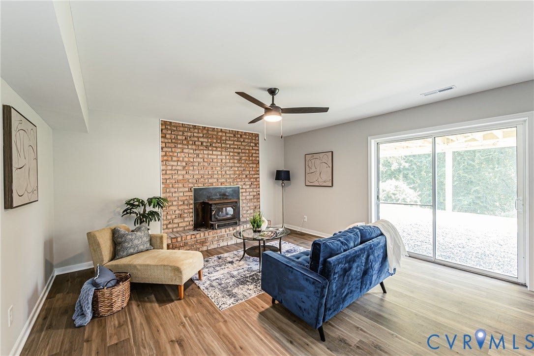 2702 Manchester Drive, New Birchett Estates, Prince George, VA 23875 Wood-finish flooring throughout, brick fireplace with hearth, ceiling fan, and sliding glass door
