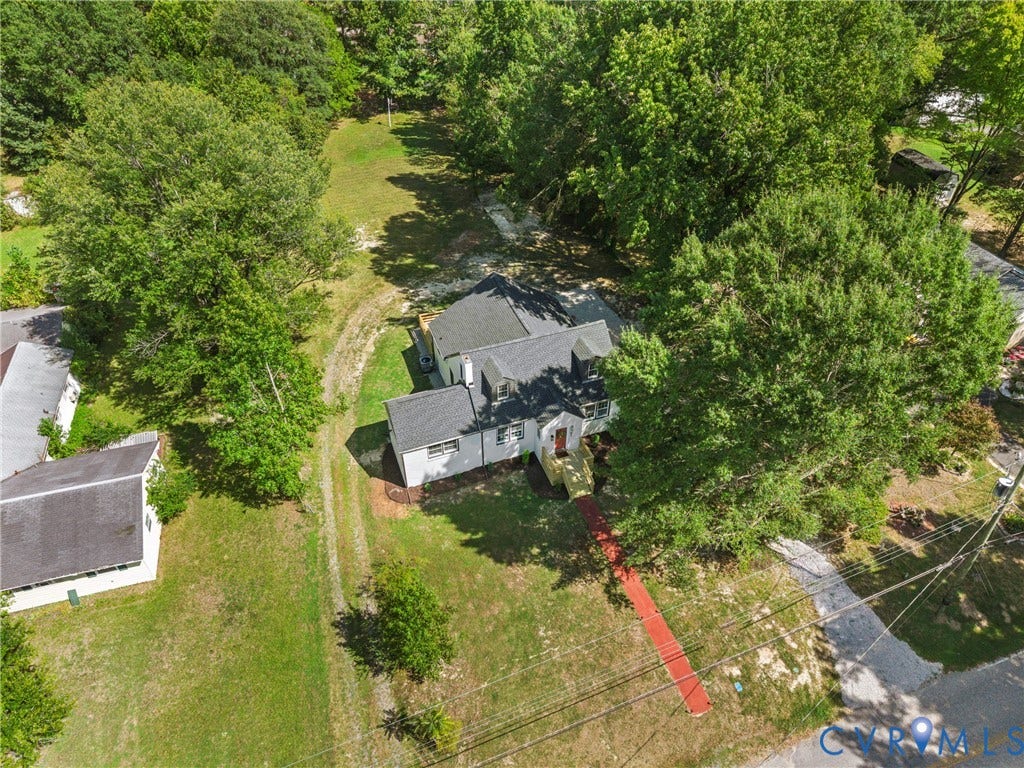 821 Fort Lee Road, North Dinwiddie, VA 23803 Expansive property with mature trees and a gravel driveway