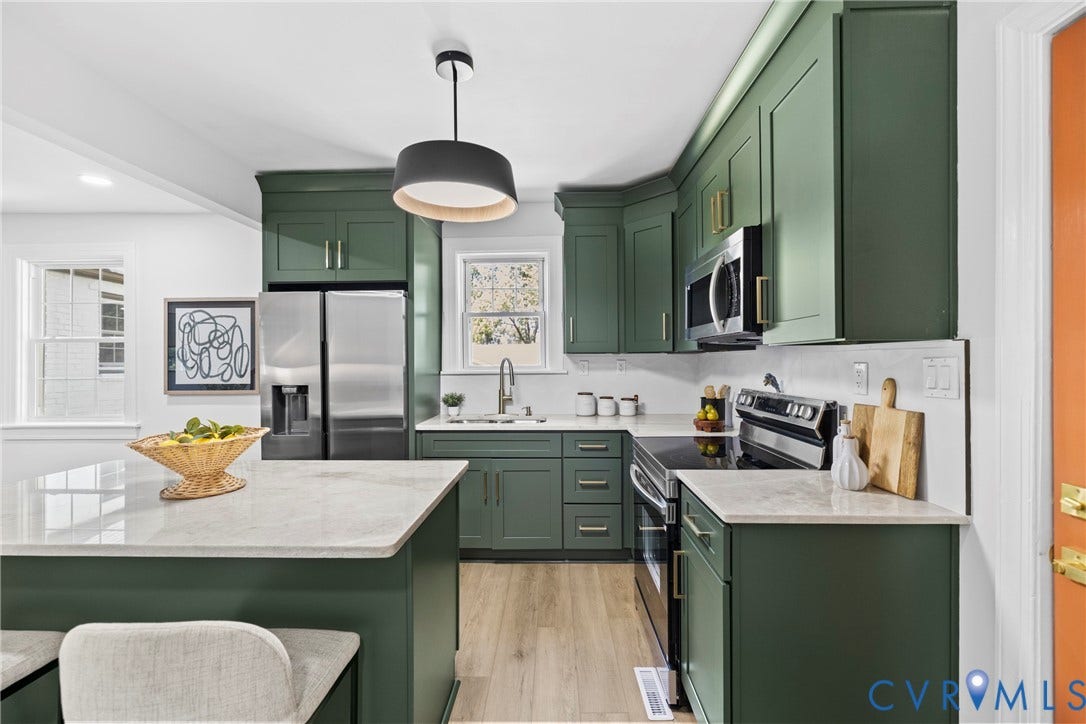 821 Fort Lee Road, North Dinwiddie, VA 23803 Kitchen featuring green cabinetry, stainless steel appliances, light-toned countertops, wood-finish flooring, and a contemporary pendant light fixture