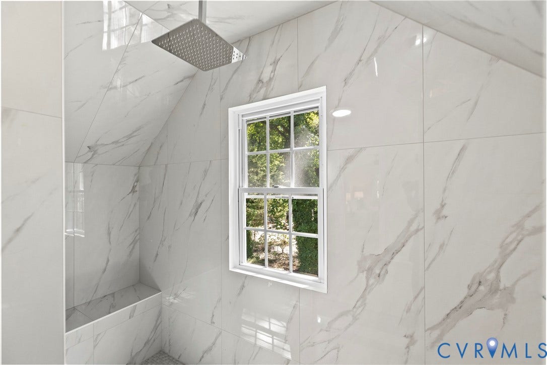 821 Fort Lee Road, North Dinwiddie, VA 23803 Shower featuring large format white and gray veined wall tiles, a built-in bench, and a rain showerhead